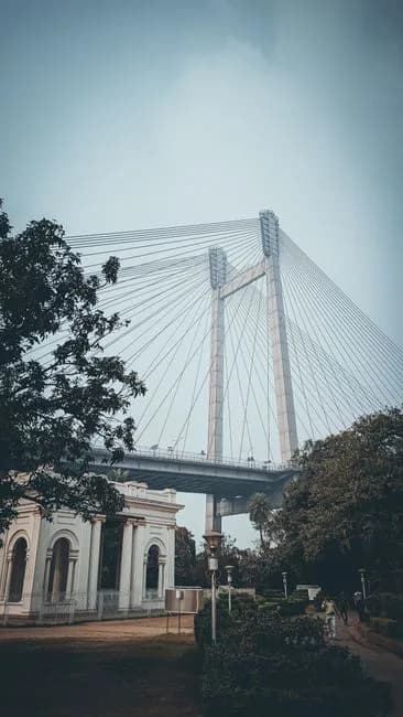 Howrah Bridge and Victoria Memorial in Kolkata West Bengal India surrounded by greenery