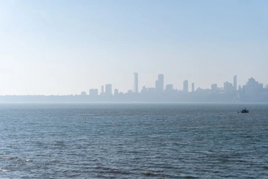 Serene view of the Mumbai skyline across the Arabian Sea with distant cityscape