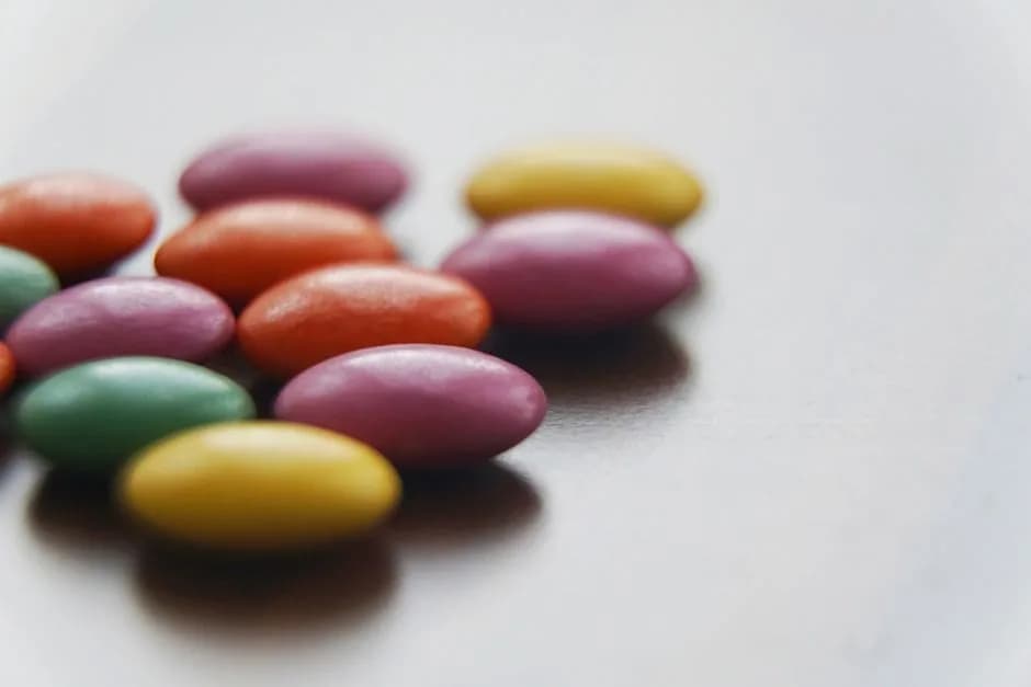 Vibrant, colorful candy-coated chocolates on a neutral background
