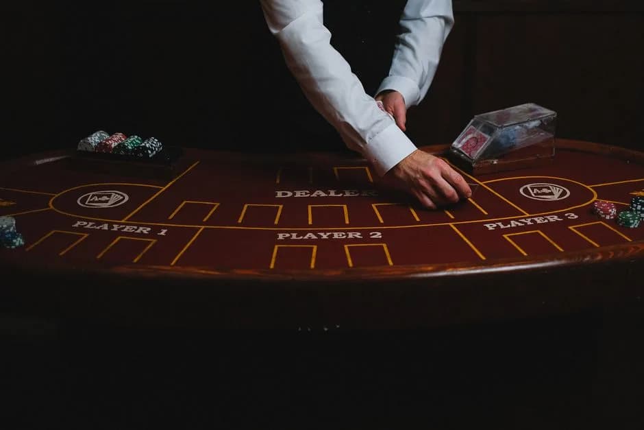 Close-up of a live dealer's hands dealing cards at a blackjack table
