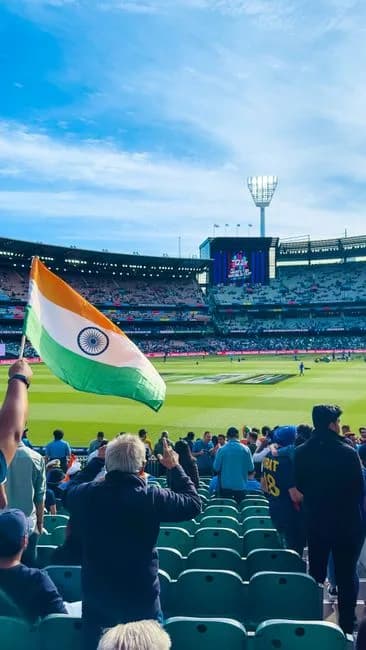 Indian cricket fans waving the Indian flag in the stands at Melbourne Cricket Ground