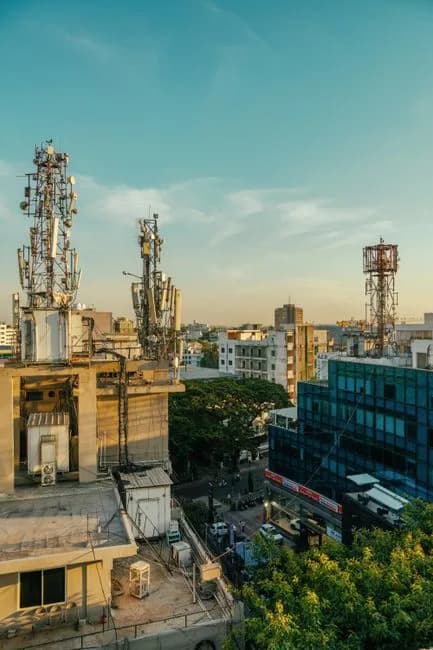 Aerial view of Bengaluru city skyline with communication towers at twilight