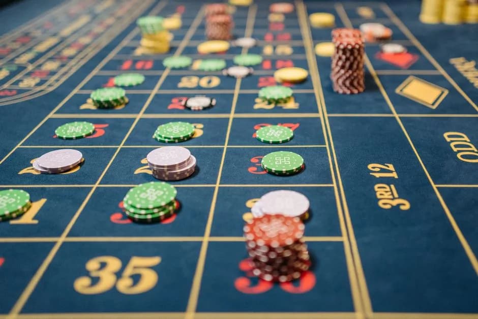 Close-up of a roulette table with colorful poker chips capturing the thrill of casino table games