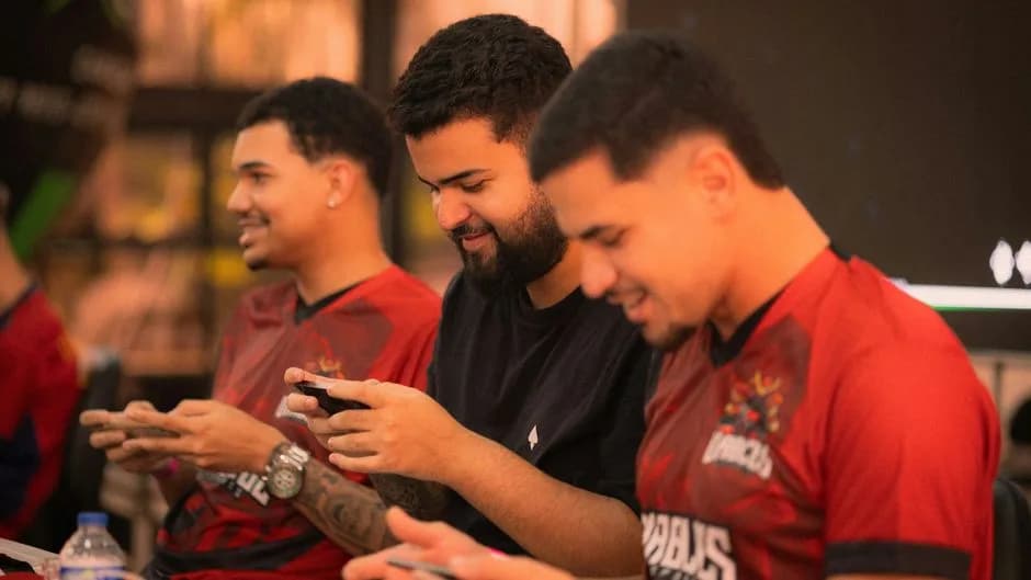 Young men competing in mobile gaming tournament