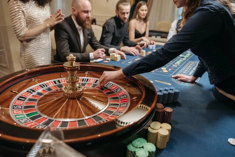 Live casino croupier spinning the ball on a roulette wheel