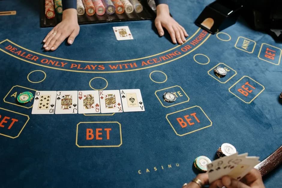 Playing cards and casino tokens on a baccarat table