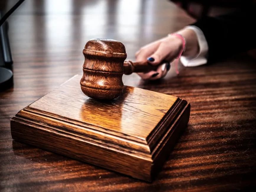Close-up of a wooden gavel on a judge's desk symbolizing law and justice