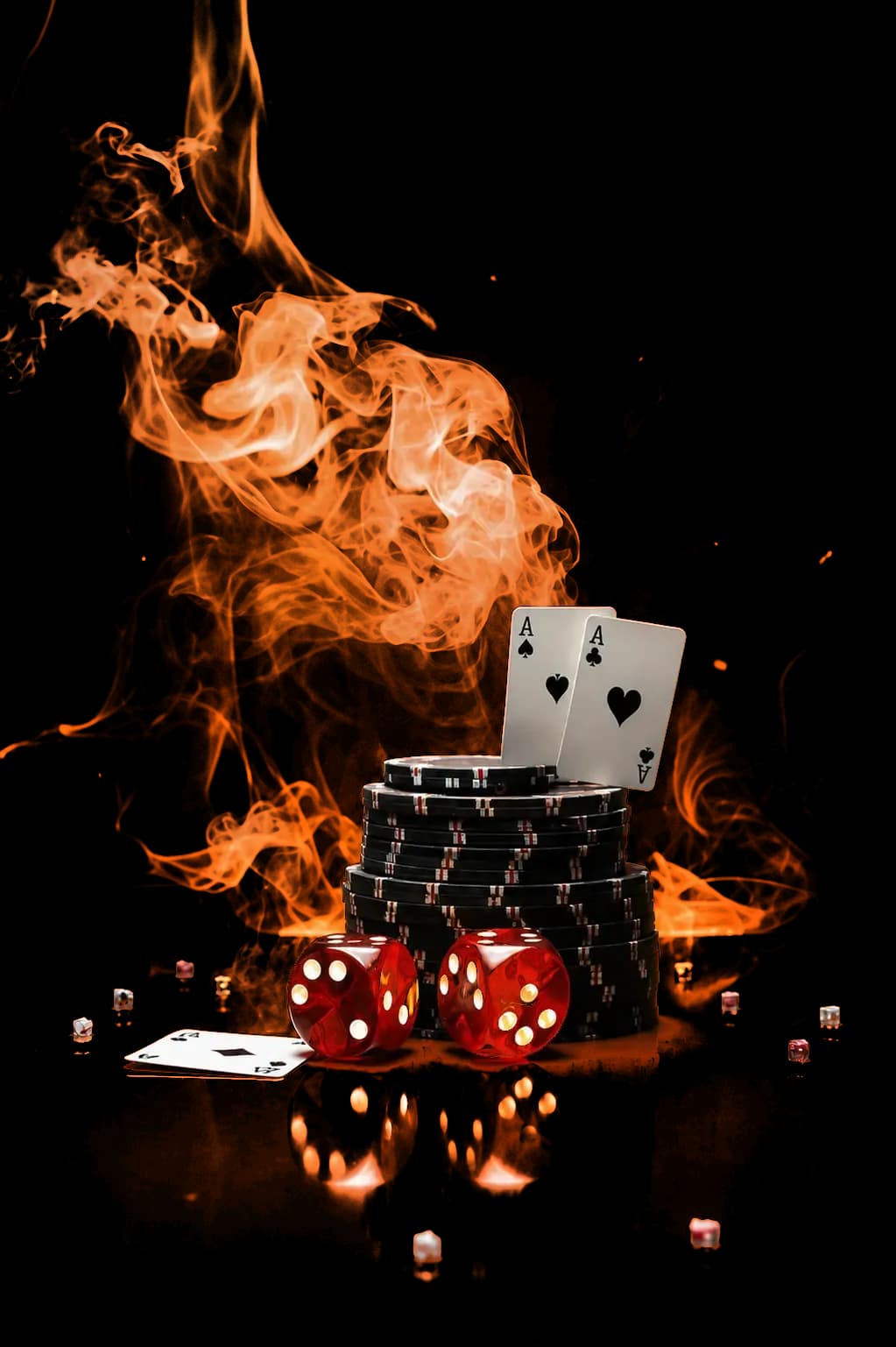Stacked casino chips, playing cards, and red dice with an orange smoke effect