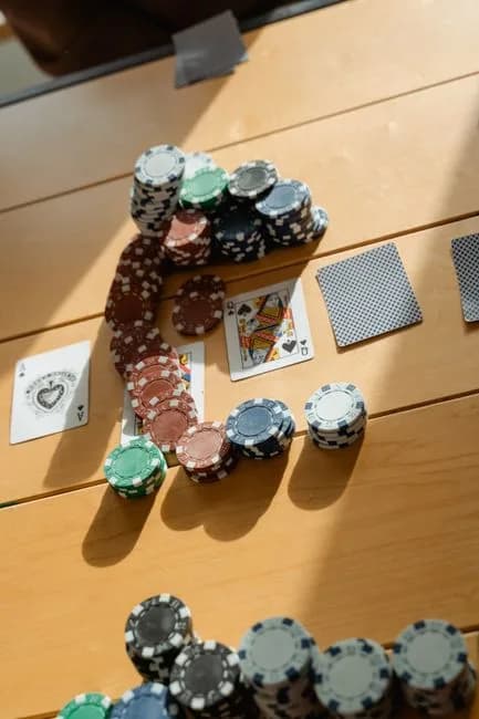 Poker game setup with chips and cards on a wooden table