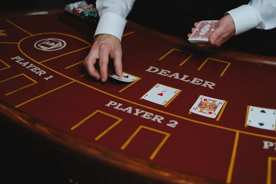 Live casino dealer distributing playing cards at a poker table