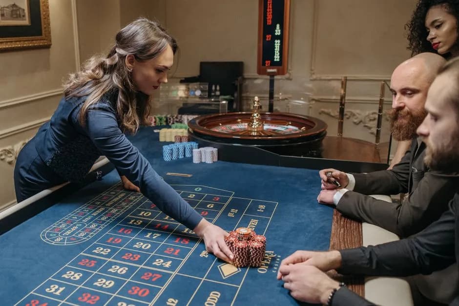 Dealer and players at a live casino roulette table