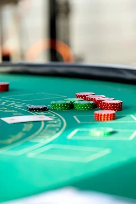 Casino chips and playing cards on a blackjack table