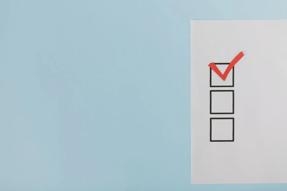 A minimalist checklist with a red checkmark on a blue background
