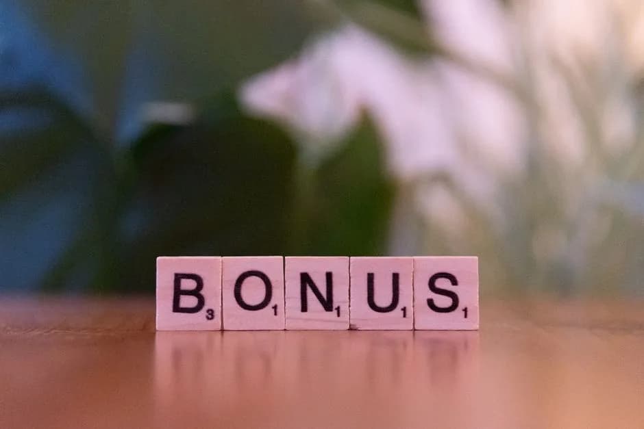 Wooden tiles spelling BONUS, representing a daily reload bonus offer