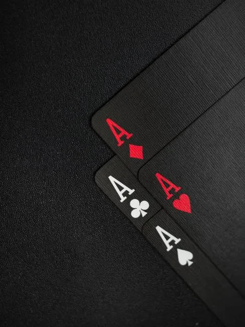 Close-up of four ace playing cards on a dark background