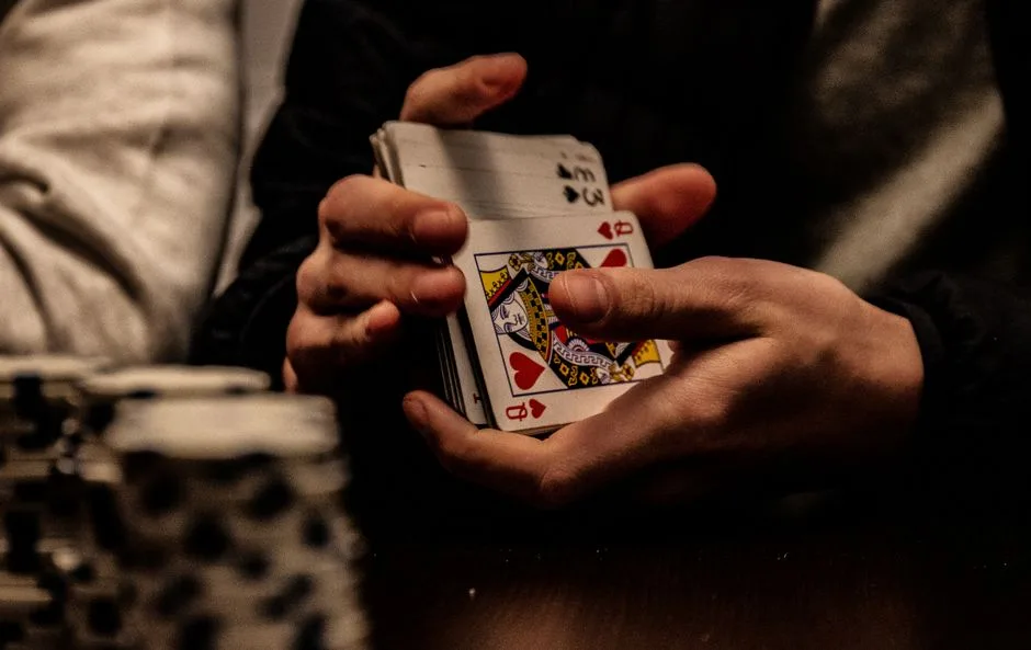 Close-up of hands shuffling playing cards during a card game