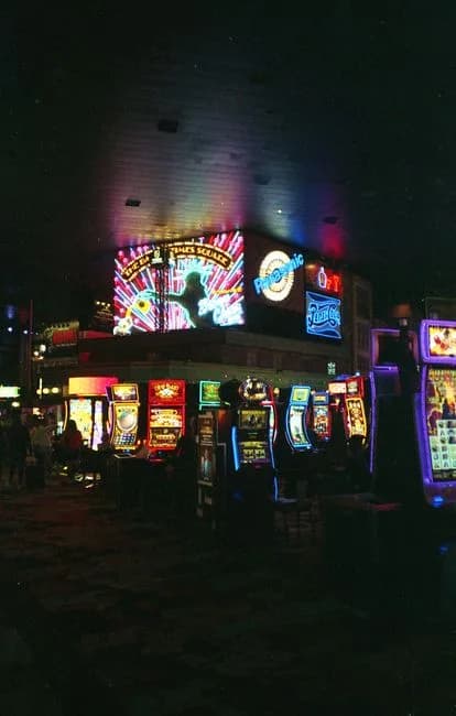 Vibrant casino scene filled with colorful neon lights and slot machines at night