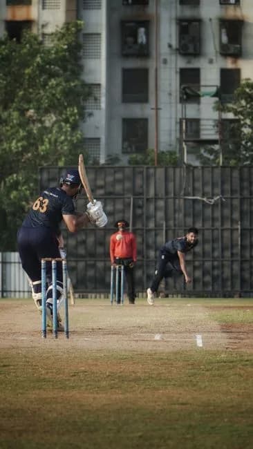 Intense cricket match action on a Mumbai field showing batsman and fielders